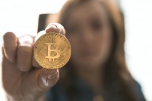 woman holding Bitcoin