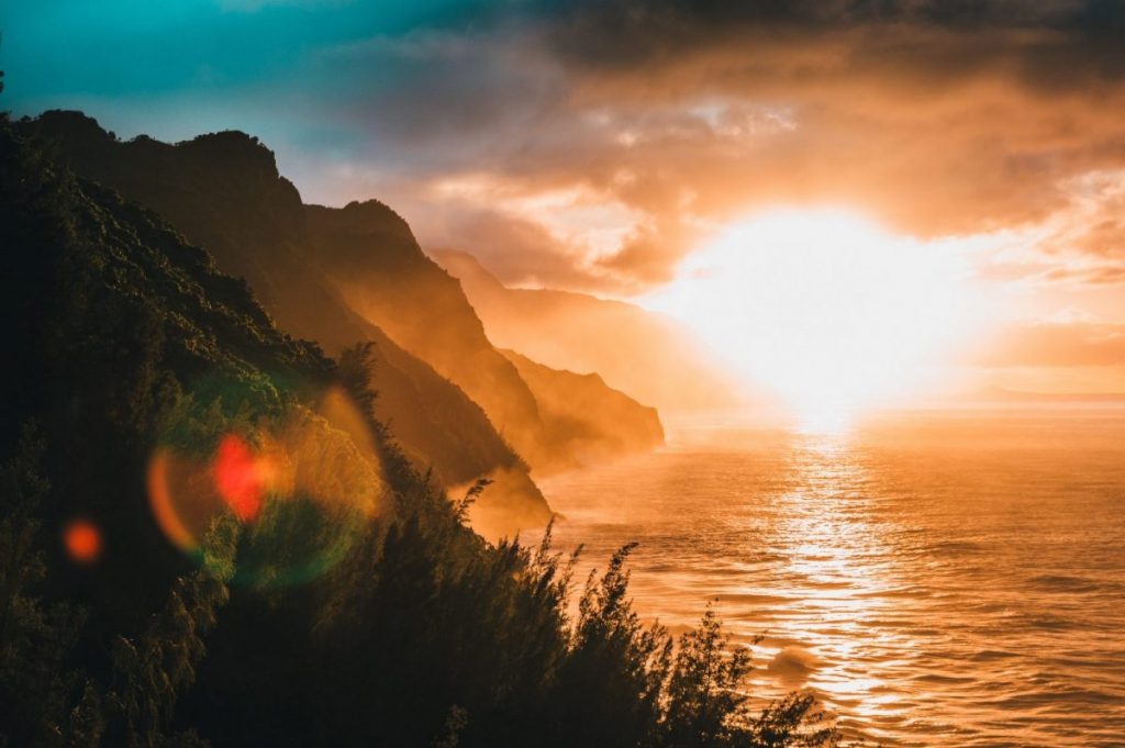 landscape photography of mountain beside body of water during golden hour