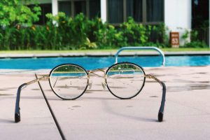 eyeglasses with black frames on white fabric