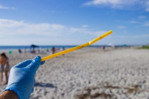 person holding yellow stick during daytime