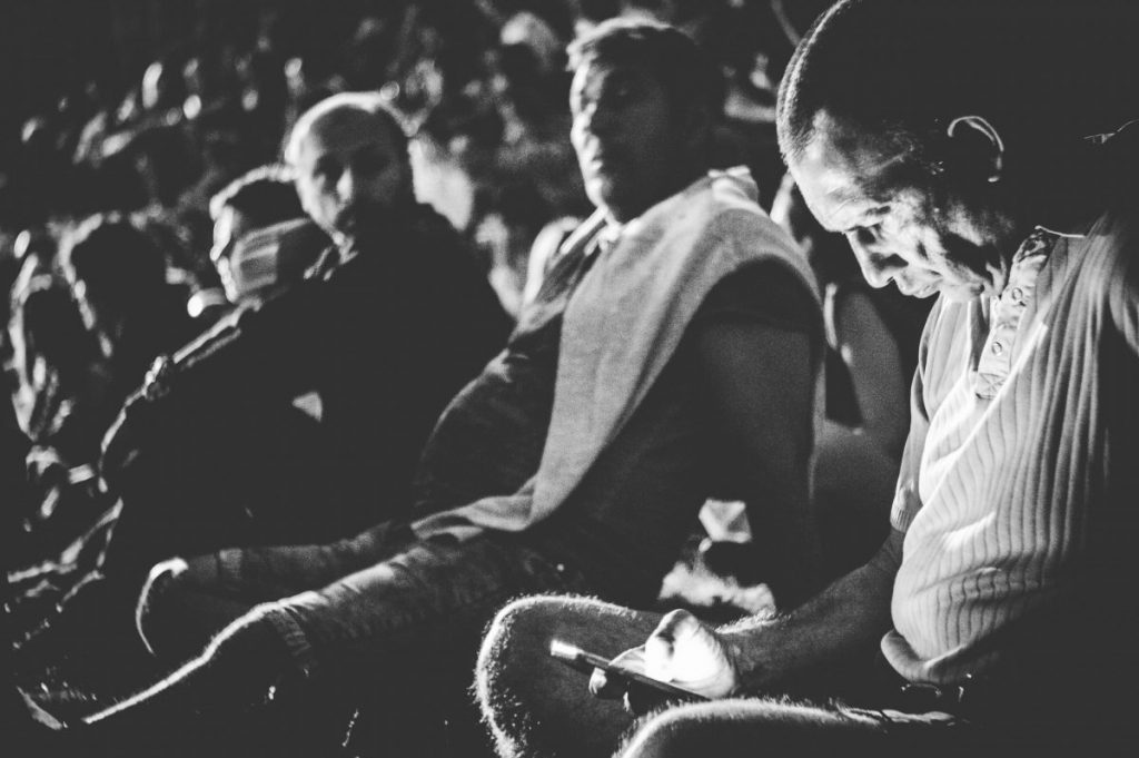 grayscale photography of man holding smartphone