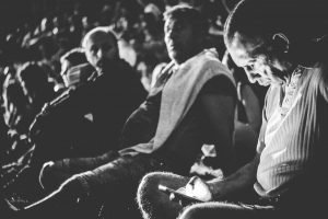 grayscale photography of man holding smartphone