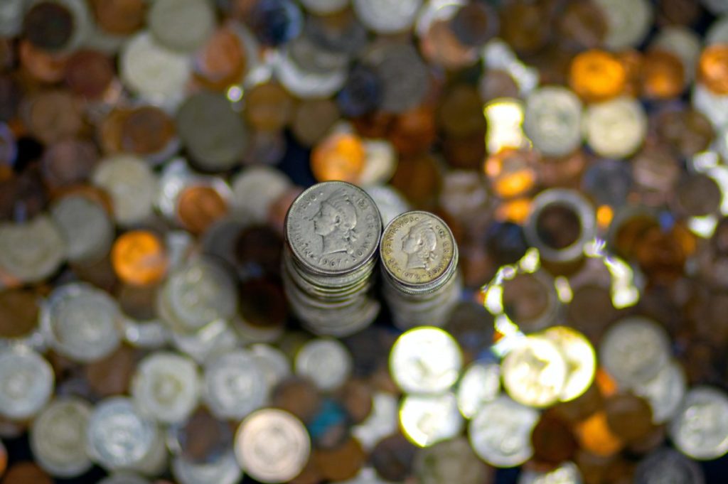 silver round coins on brown wooden table