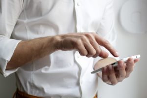 person holding white Android smartphone in white shirt