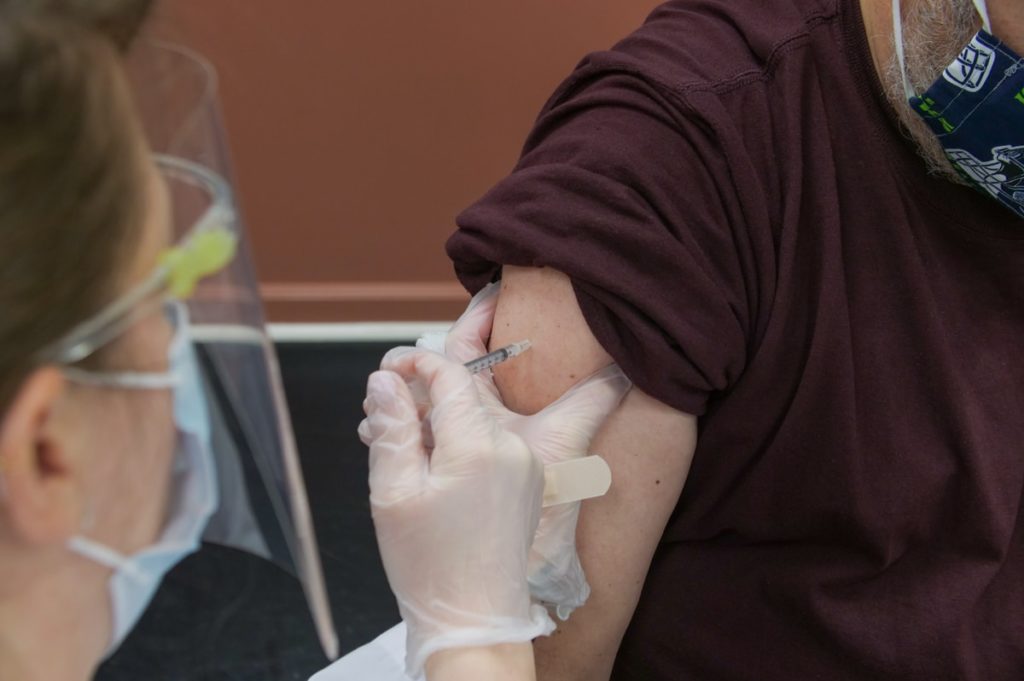 person in brown long sleeve shirt with white bandage on right hand