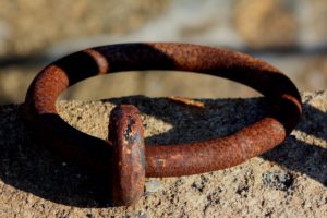 brown metal chain on gray rock