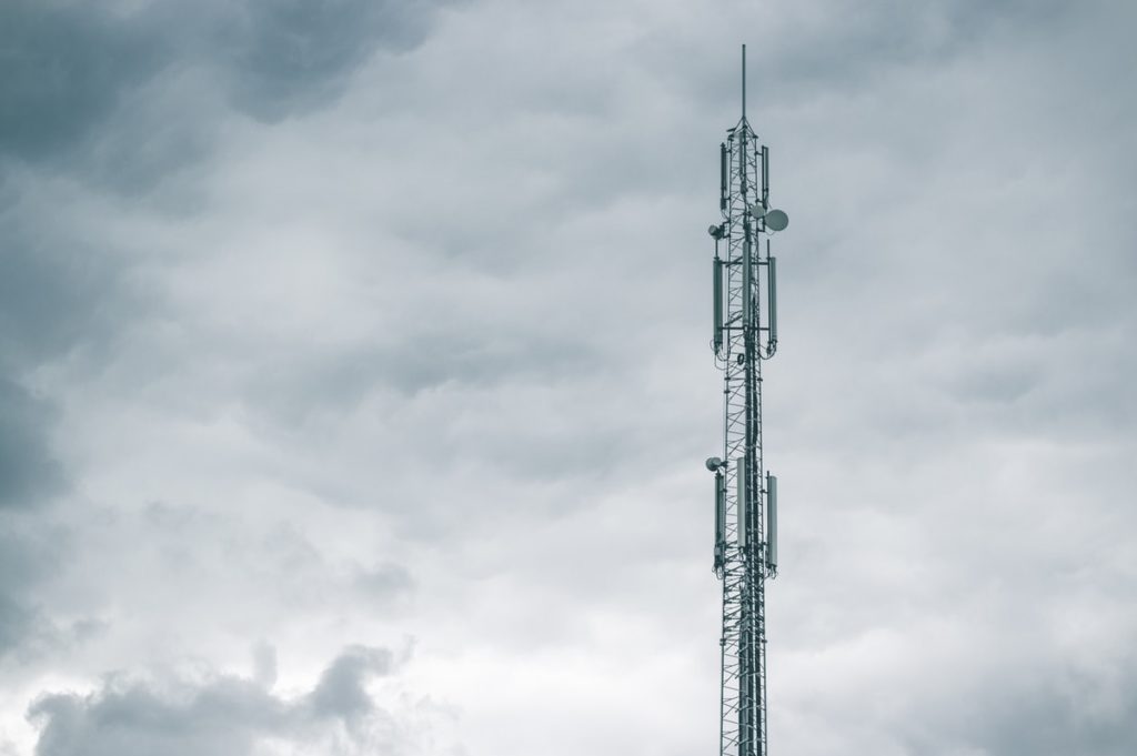 gray radio tower under the cloudy sky during daytime