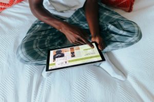 Person in pajamas clicking on their Surface laptop