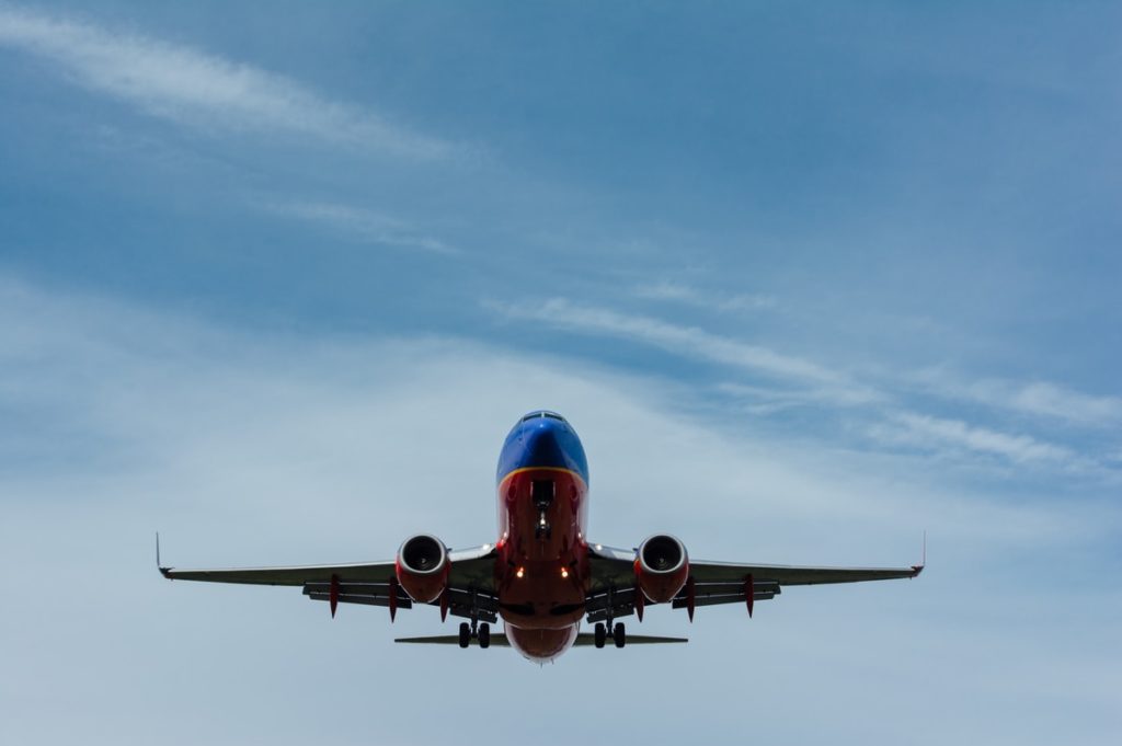 blue and red airplane on sky