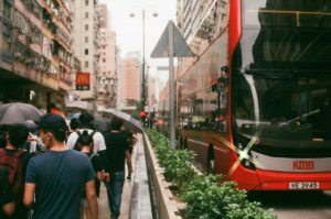 people walking beside bus